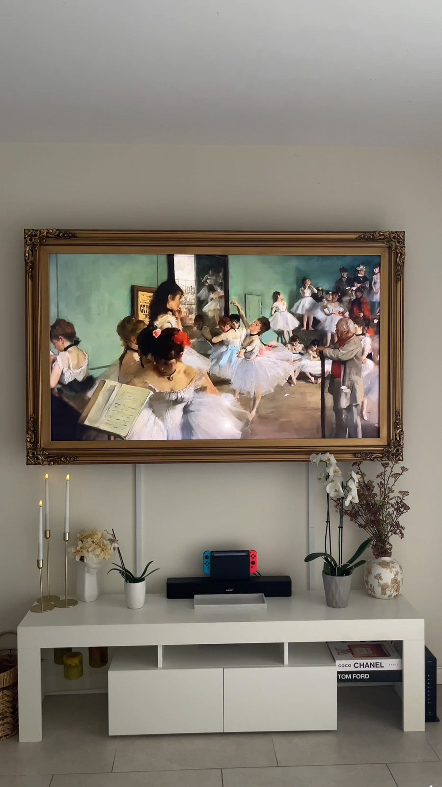 The installed gold frame surrounding a TV in a living room
