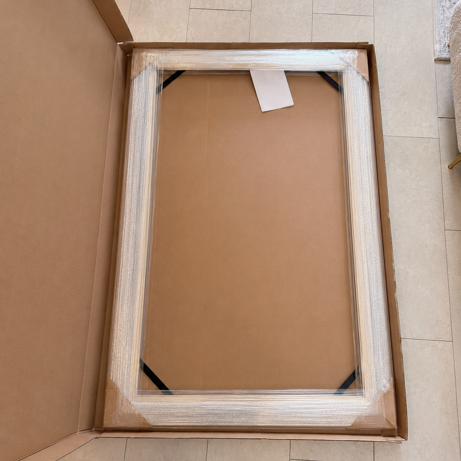 A fully assembled TV frame protected inside its shipping box