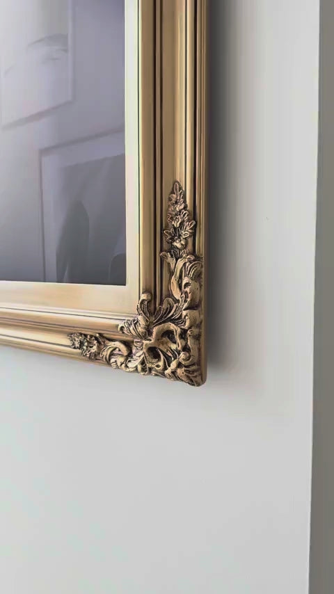 Close-up video of the corner and painted details of a gold TV frame